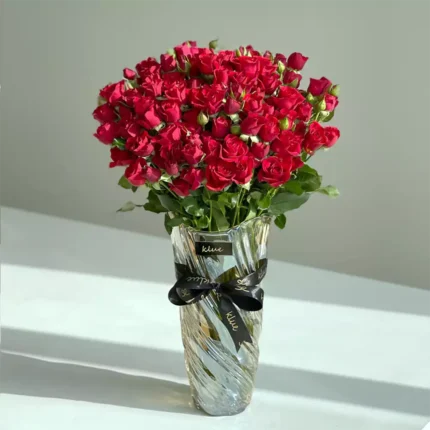 Red baby roses vase